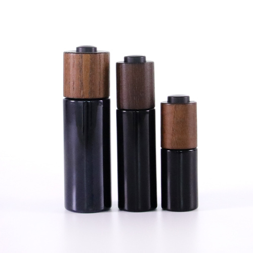 Black glass bottle with wooden lid for serum