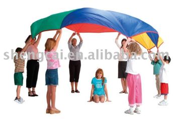 Beautiful children play rainbow parachute