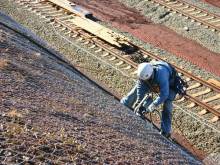 Rock cage retaining wall for highway
