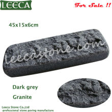 Dark grey tumbled granite stone paving