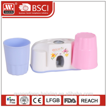 Plastic auto-toothpaste squeezer w/two cups