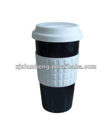 ceramic coffee cup with silicone lid and sleeve