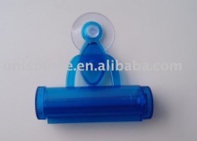 Toothpaste squeezer with hang suction