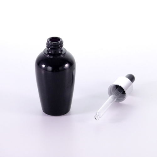 Botella de vidrio negro con tapa plateada
