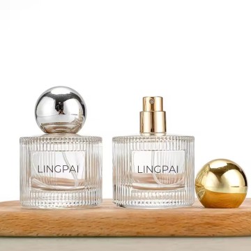 Recyclable 40ml vertical striped glass perfume bottle with ABS gold and silver black round ball cap