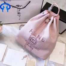 A drawstring backpack carries a women's bag shopping