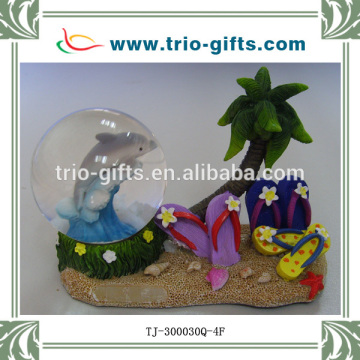 polyresin dolphin and sandles snow globe item