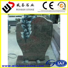 Black granite memorial tombstone with flowers