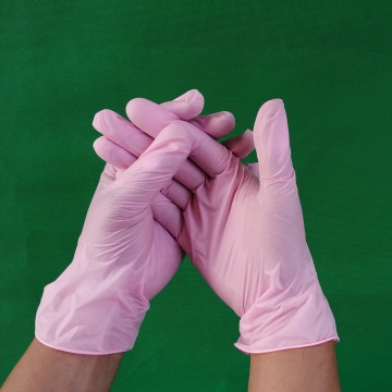 Salon de beauté des gants en vinyle rose