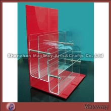 Trilaminar crystal acrylic magazine holder with red backdrop