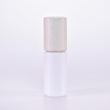 White glass roll on bottle with wooden lid