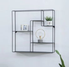 Metal wall-mounted shelf next to the TV