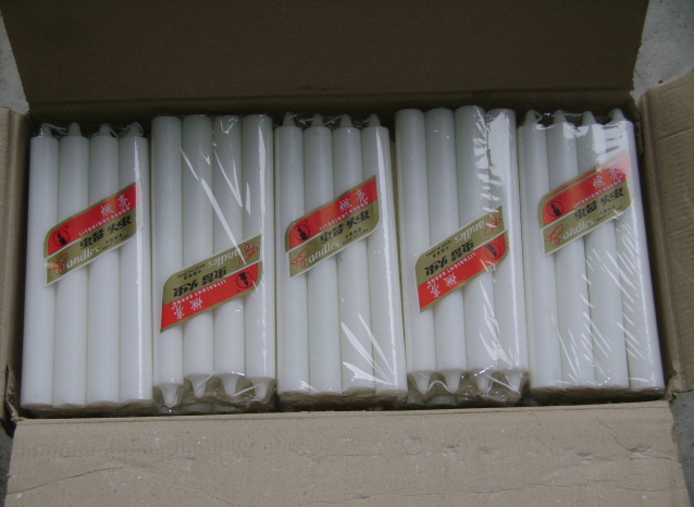 white household candle with cellophane packaging