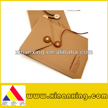 yellow paper envelopes with button and string closure