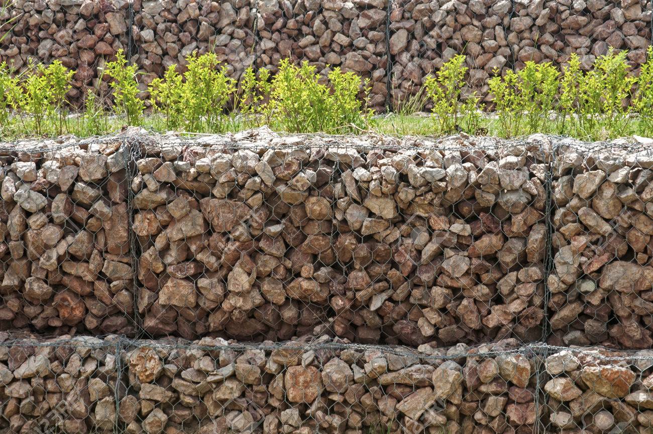 61128801-hexagonal-wire-netting-gabion-box-wall-filled-with-stones-closeup-as-background