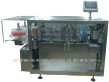 Automatic plastic ampoule or vial filling and sealing machine