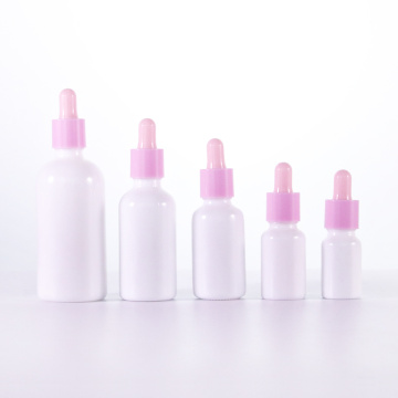 Botol minyak esensial putih opal dengan penetur merah muda