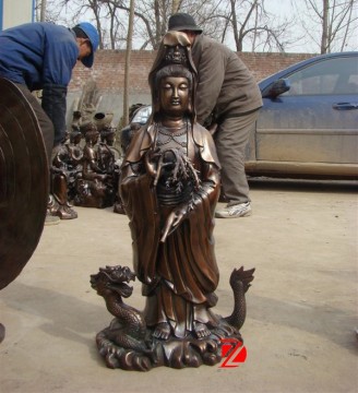 bronze kuan yin statue standing on dragon sculpture