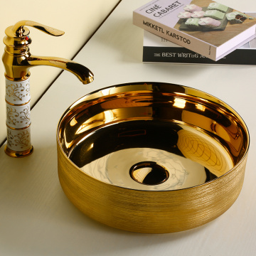 Golden and black color luxury ceramic wholesaler bathroom round washbasin with Counter top sink new design art basin