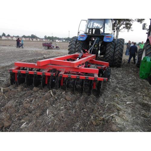 Disc ploughs harrows farmland Tractor