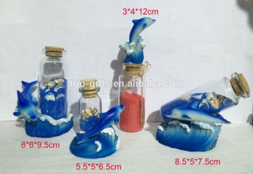 polyresin dolphin souvenir item with sand bottle