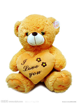 Plush bear with heart pillow