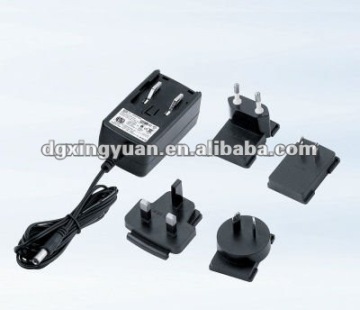 Universal power adaptor with interchangeable plugs