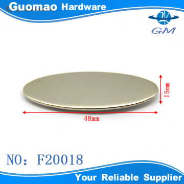 Oval nickel with prongs handbag logo plate