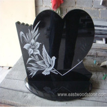 Black headstone with flower