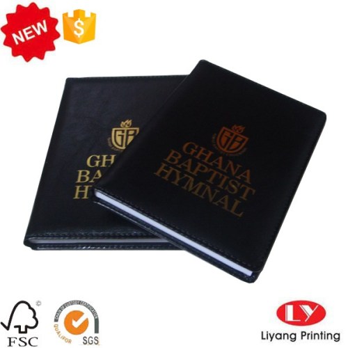 Cuaderno de piel con logo dorado.