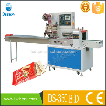 Automatic flow wrapping machine with film roll