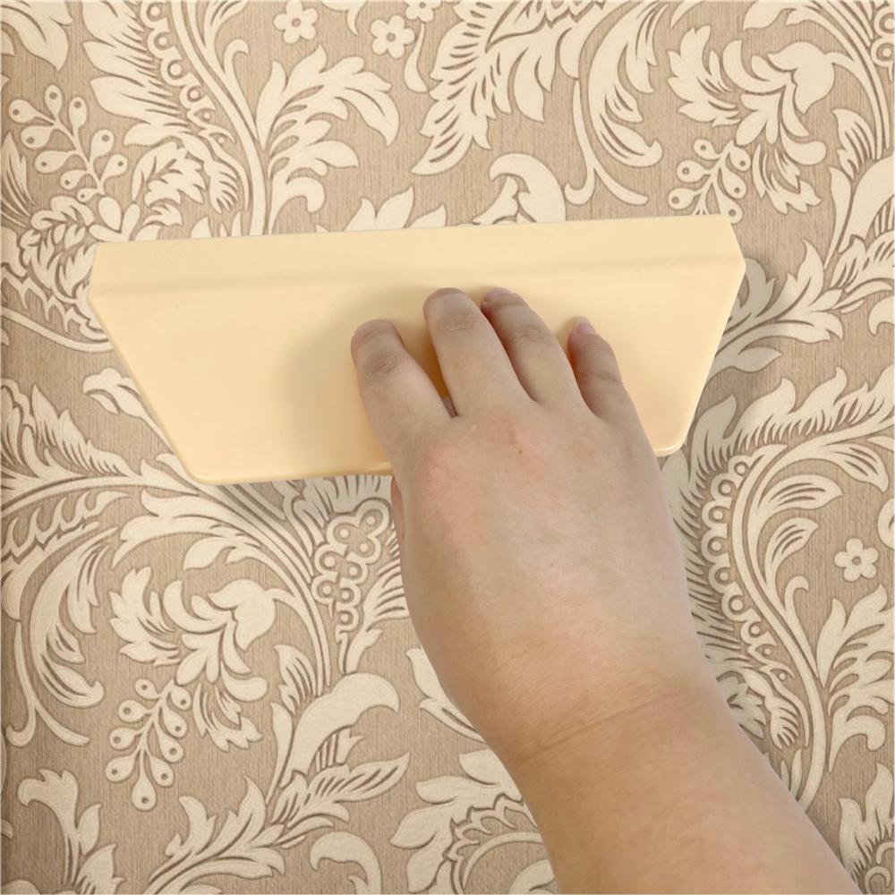 Plastic scraper for interior wallpaper decoration construction