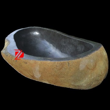 hand carved freestanding river stone bathtub