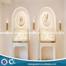 small glass and wooden jewelry counter display stands