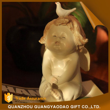 Miniature seated innocent baby with a pigeon angel statue resin figurine