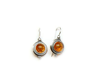 Delicate silver stud earrings with orange amber