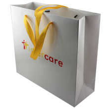 Beutiful white paper gift bags with ribbon handle