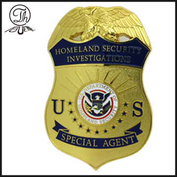 Gold US Homeland Security badge metal