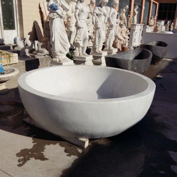 white marble round stone bathtub