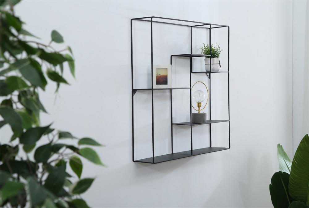 Metal wall-mounted shelf next to the TV