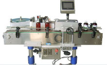 Adhesive bottle label machine