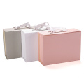 Caja de envasado de regalo de cierre de cinta rosa con manijas