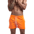 Пользовательские спортивные шорты оранжевых мужчин