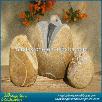 carved stone bird decorations