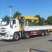 Isuzu dump truck with accompanying crane