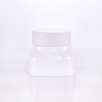 Tarro de crema de vidrio de forma cuadrada con gorras blancas