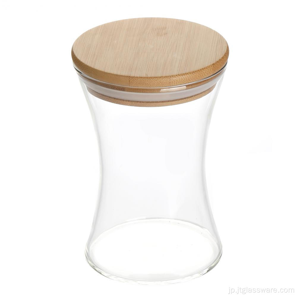 竹のふたが付いている砂時計形のガラス瓶
