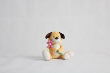 Super soft material holding flowers on ears stuffed dog doll