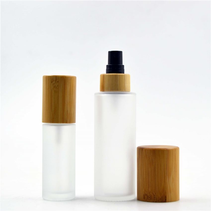 Frosted glass pump bottles with bamboo cosmetic lid