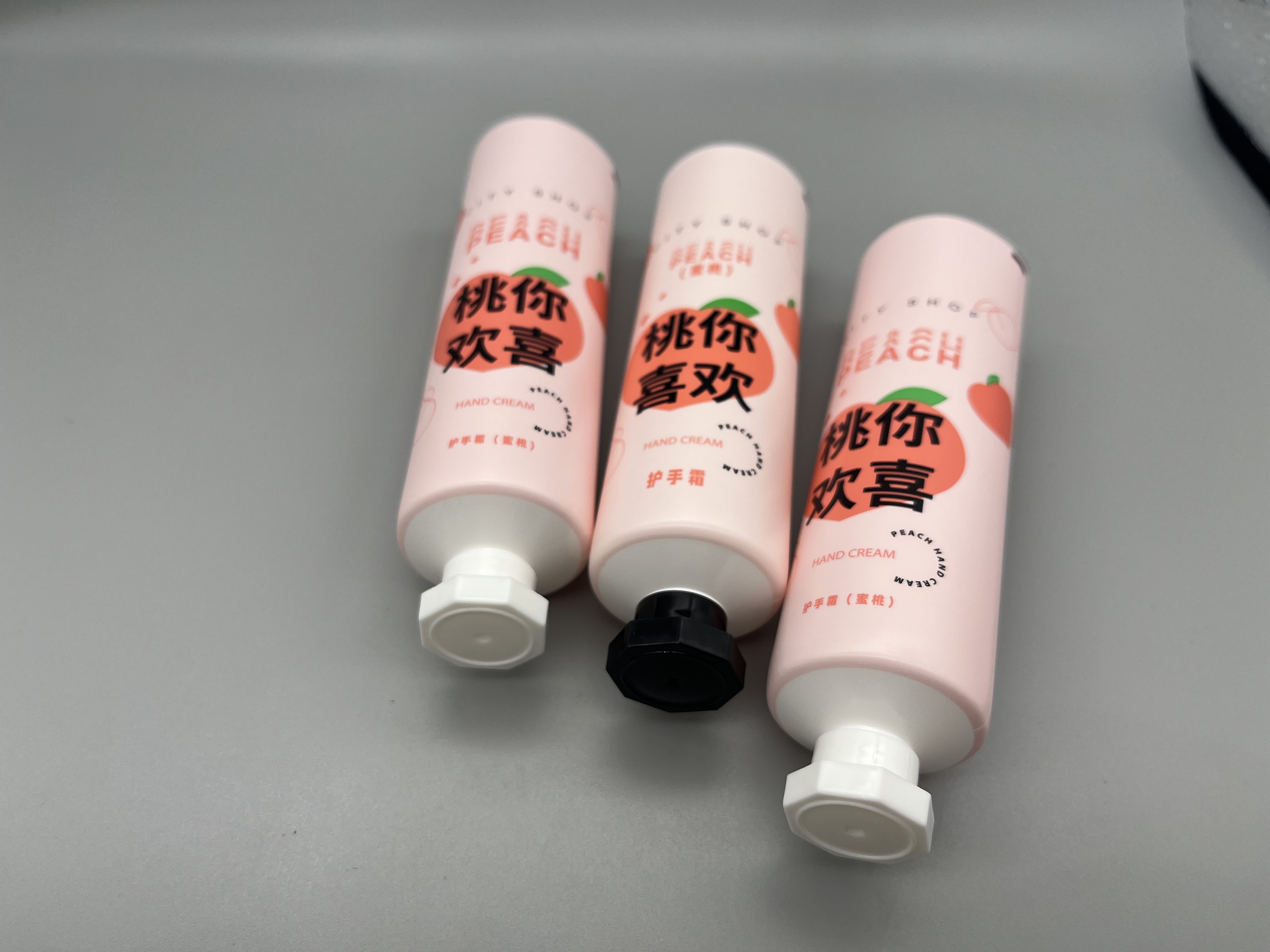 pink hand cream tube with octagonal cap 